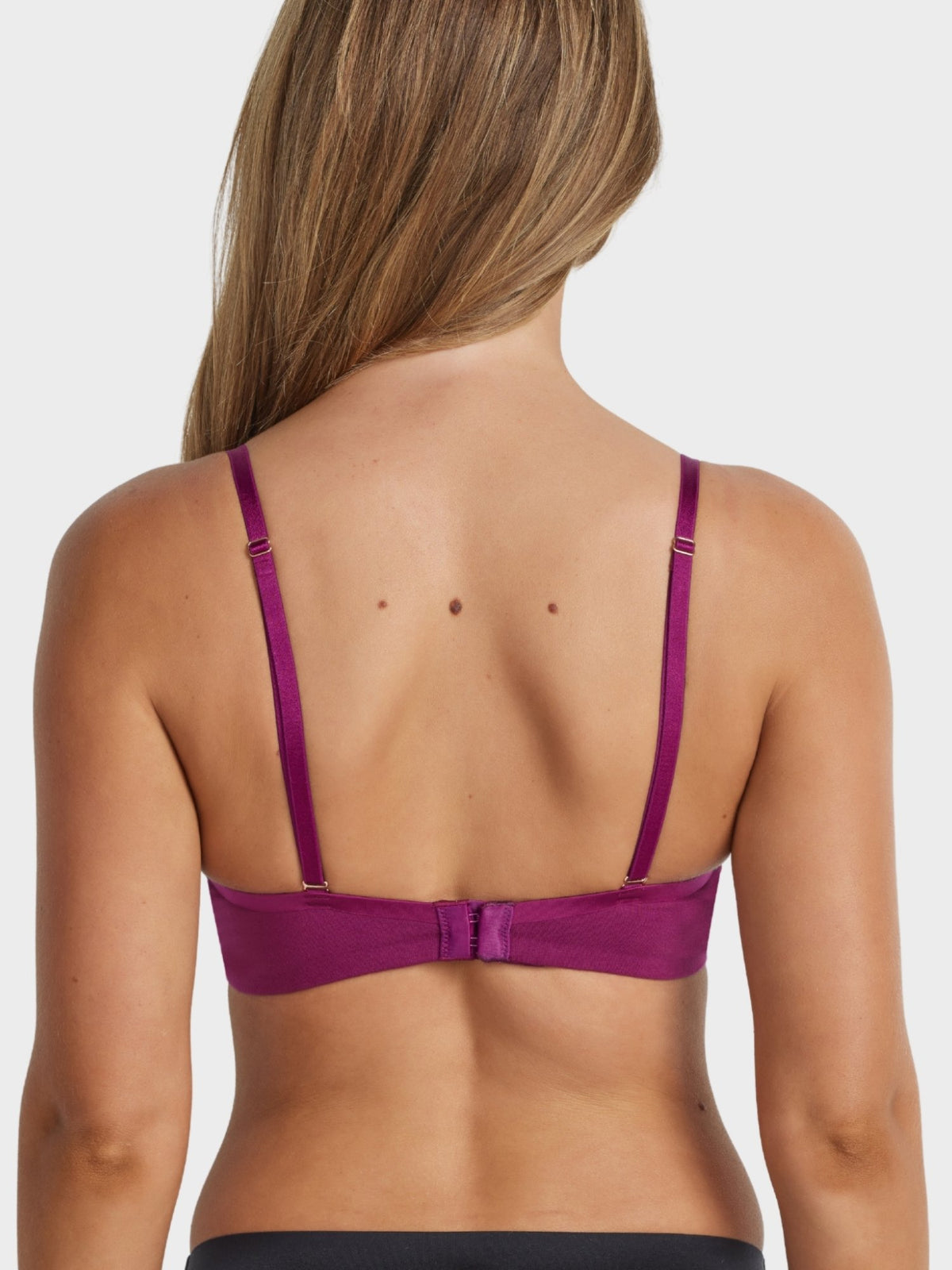 Cotton Plunge Bra in Plum worn with criss-cross straps, highlighting convertible strap design and smooth cotton finish