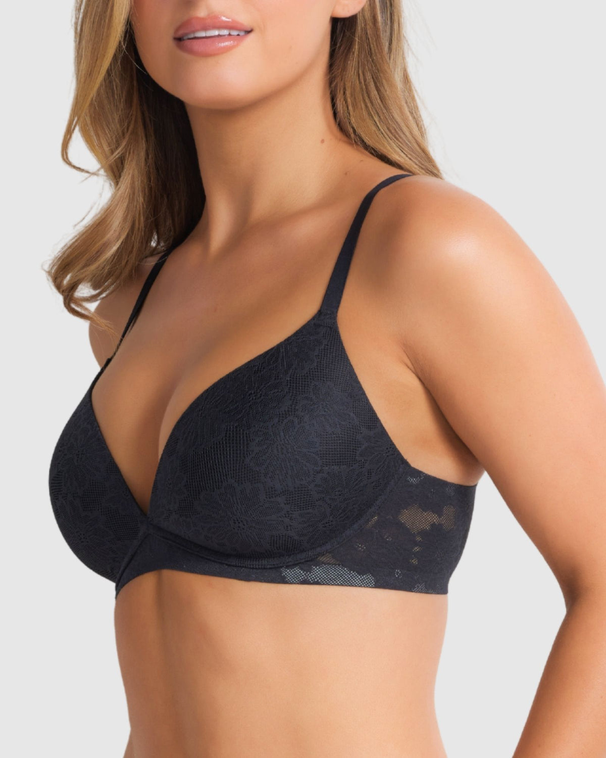 Model turning slightly to reveal both front and side view of the bra’s plunge, lace wings and natural shape.