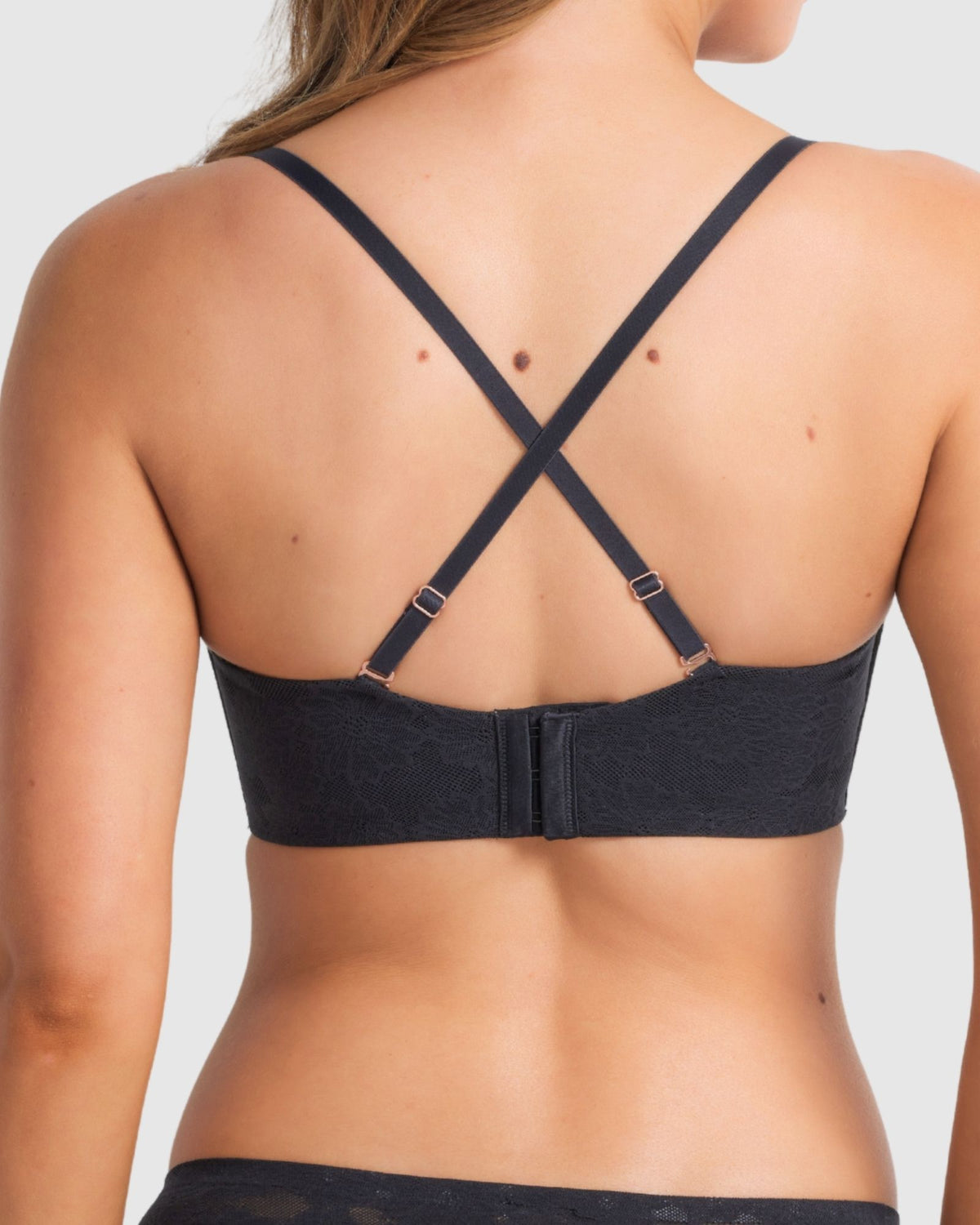 Model wearing the bra converted to criss-cross straps, showing versatility and secure fit.