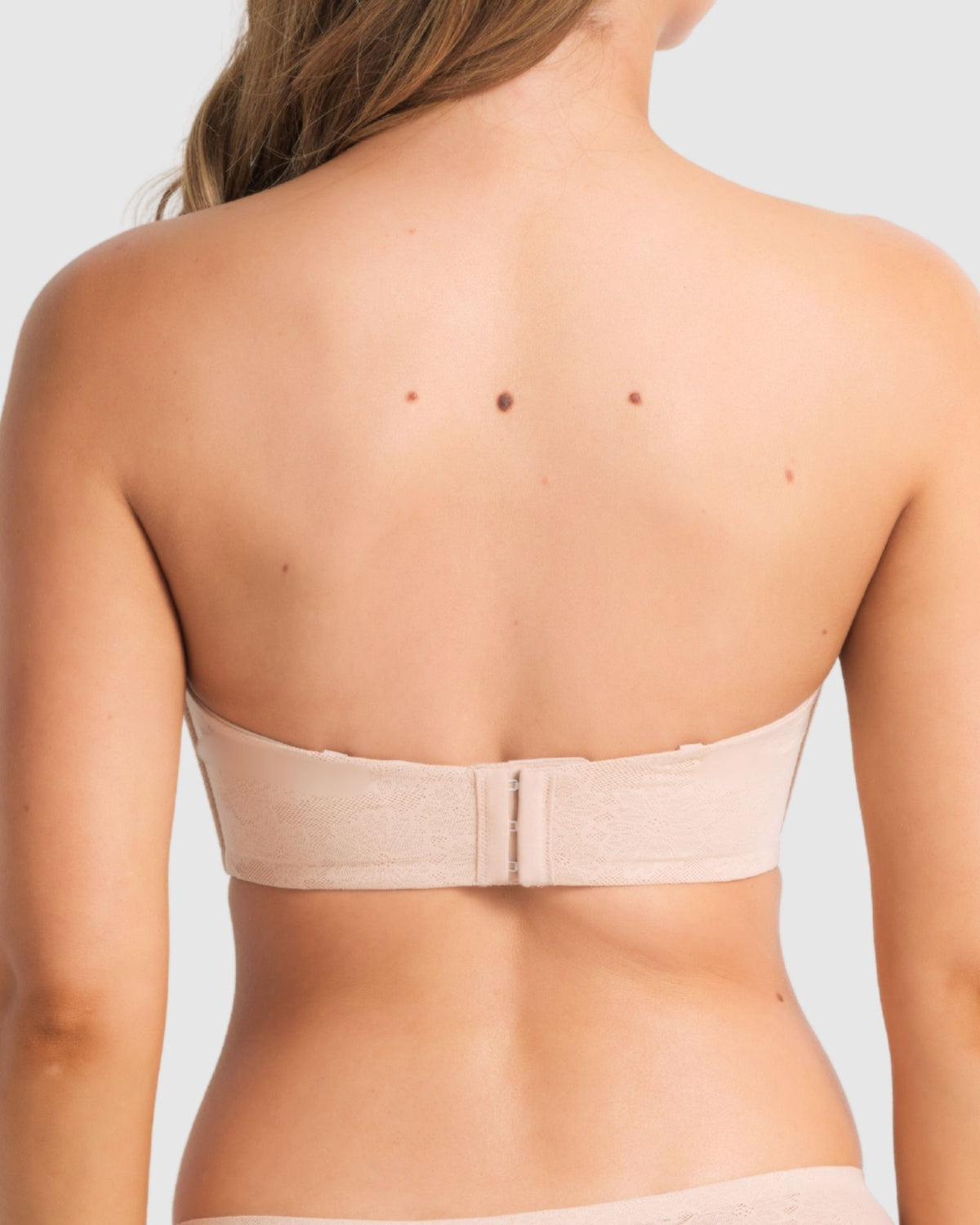 Back profile of the strapless bra worn without straps, showing smooth fused finishes and silhouette.