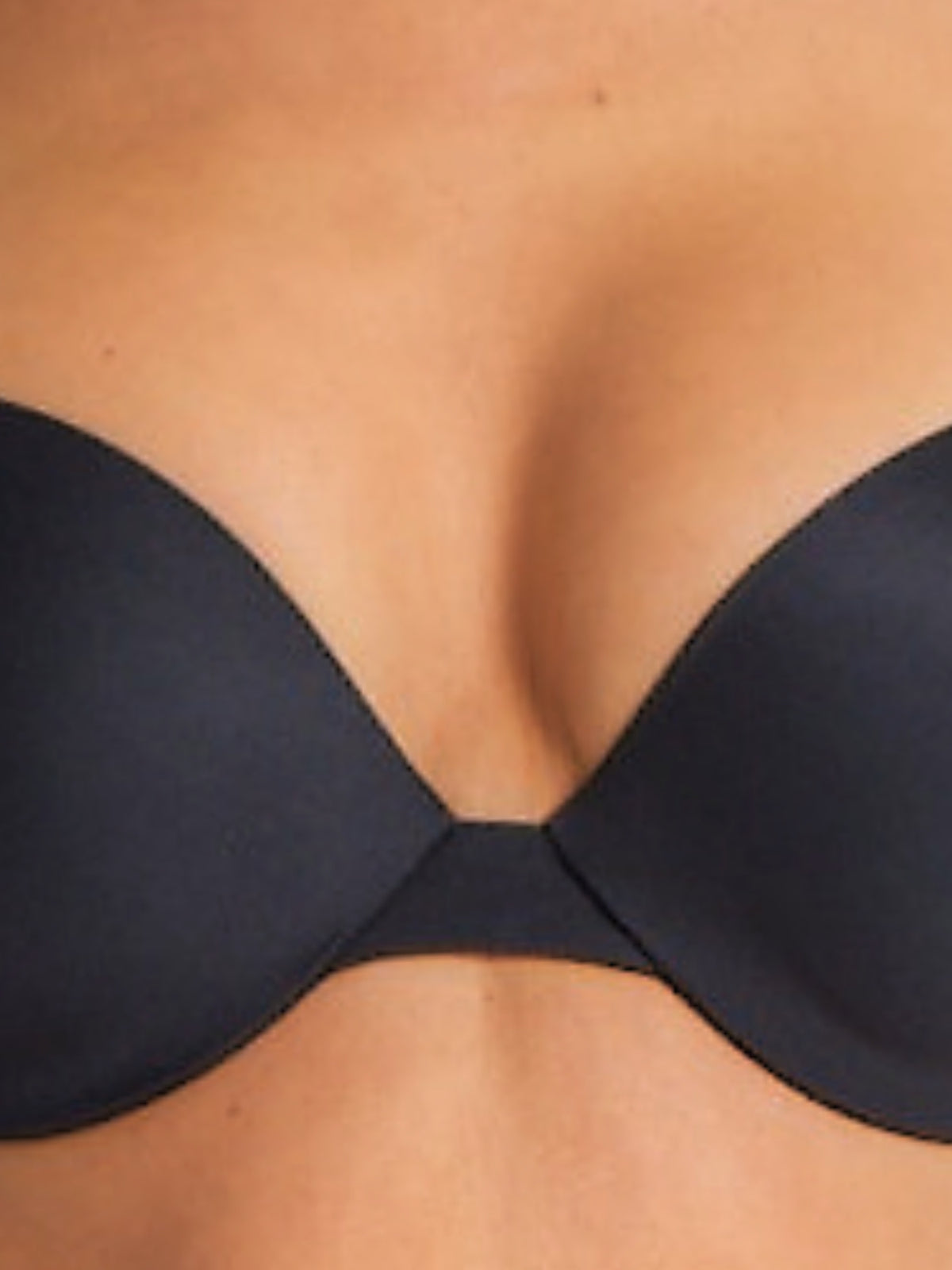 Close-up of black plunge bra highlighting soft micro fabric and push-up detail