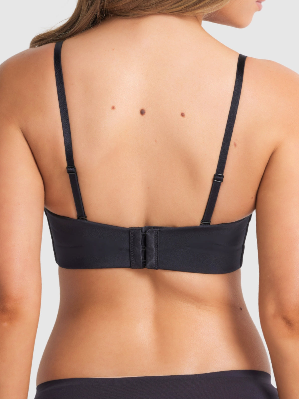 Back of full coverage black bra showing regular straps conversion.
