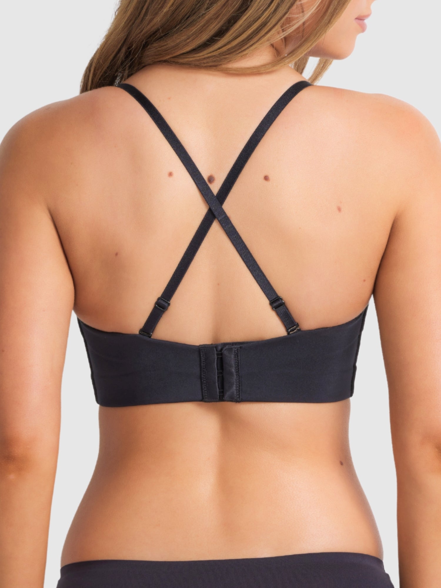 Front view of black strapless plunge bra with smooth finish and supportive structure.