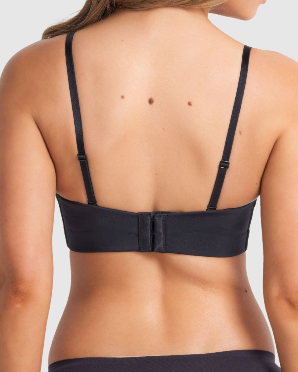 Back of full coverage black bra showing regular straps conversion.
