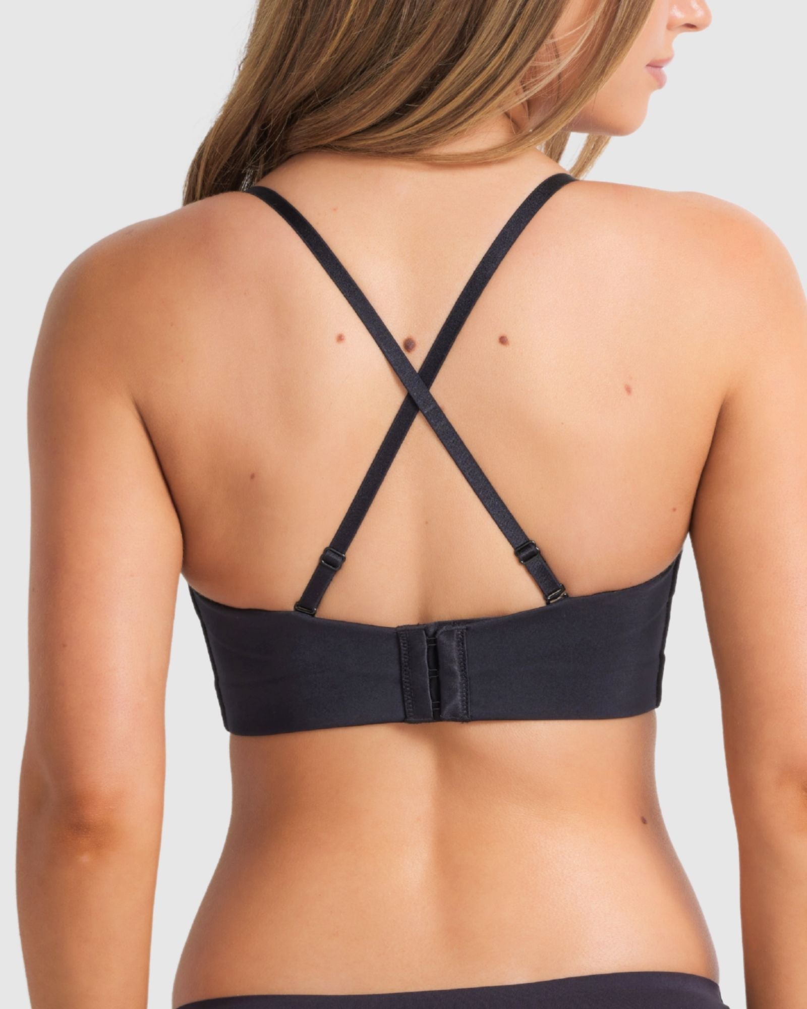 Front view of black strapless plunge bra with smooth finish and supportive structure.
