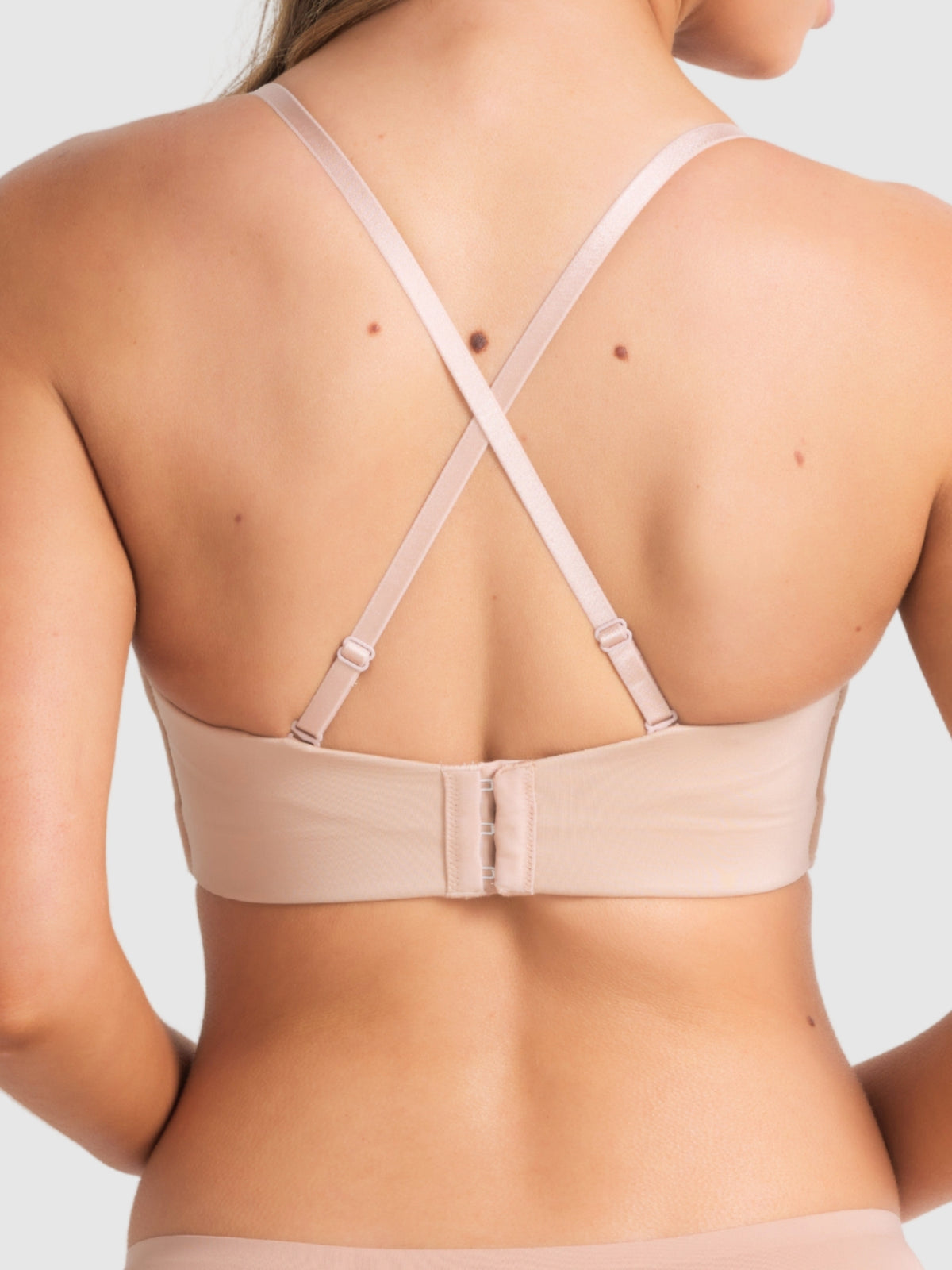 Back image of Caramel plunge bra with crossed straps for racerback support.