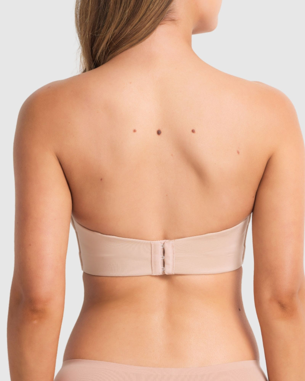 Back image of strapless black bra featuring sculpted band and hook-and-eye closure.