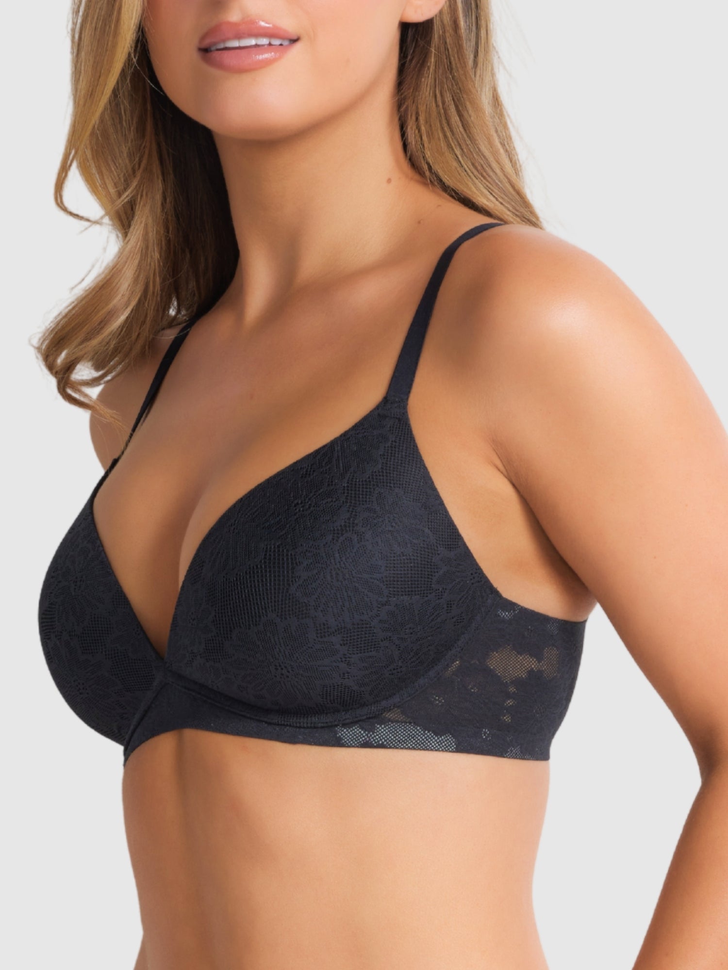 Model wearing the Weightless Wirefree Plunge Bra in Black by Fine Lines Lingerie, highlighting the deep V neckline and sculpted shape.