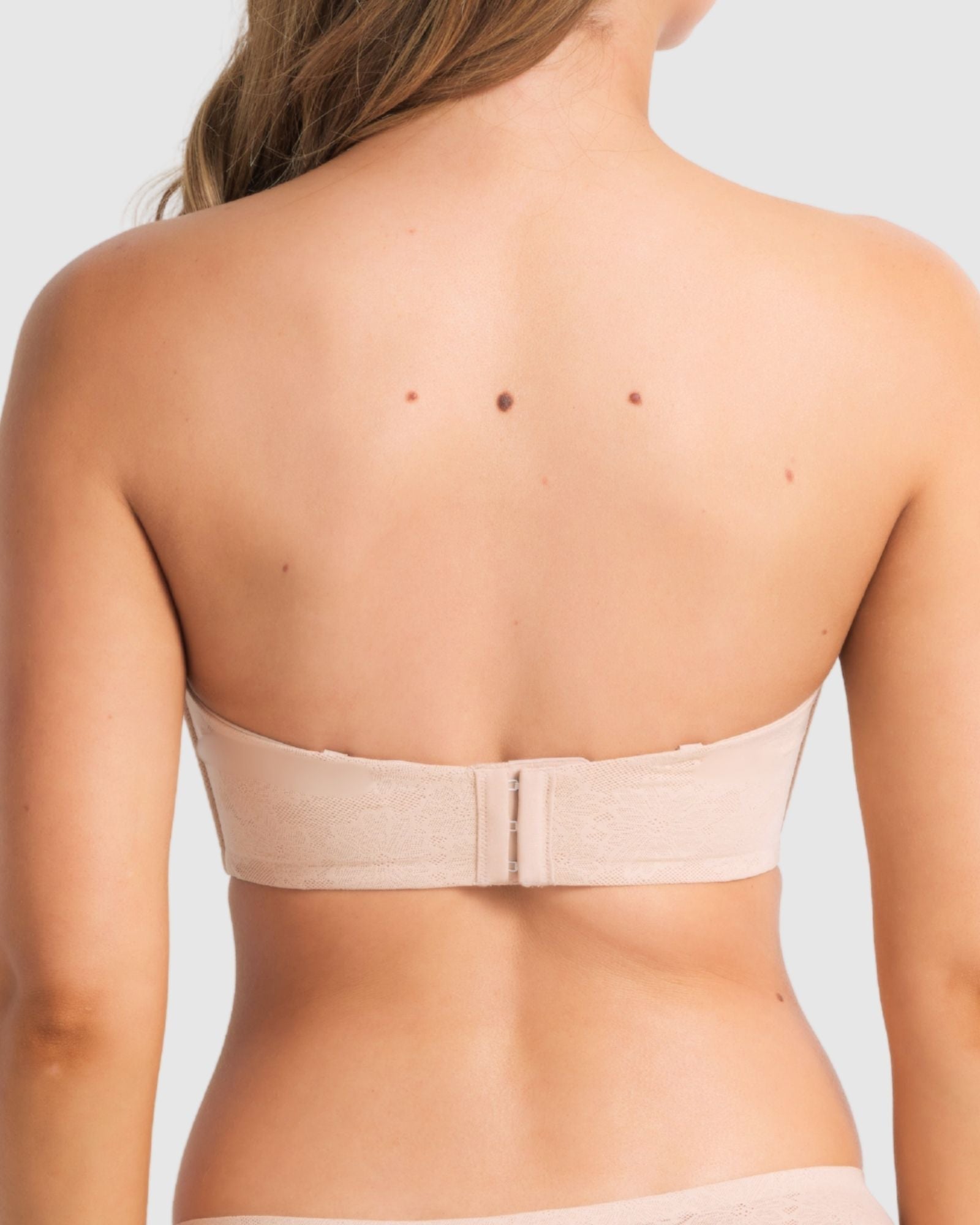 Model wearing the bra in strapless mode, focusing on secure fit and side boning support.