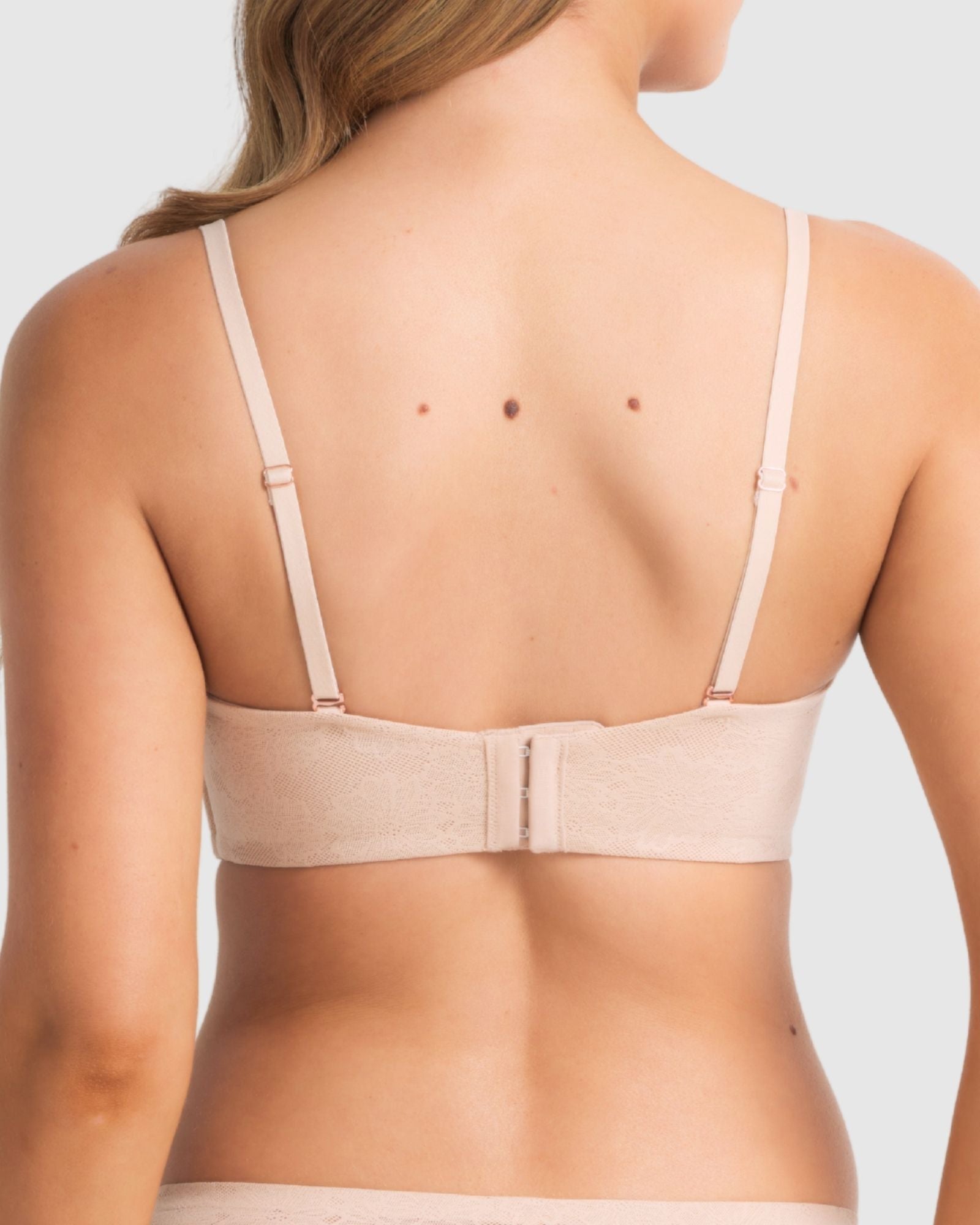 Model wearing the bra in strapless mode, focusing on secure fit and side boning support.