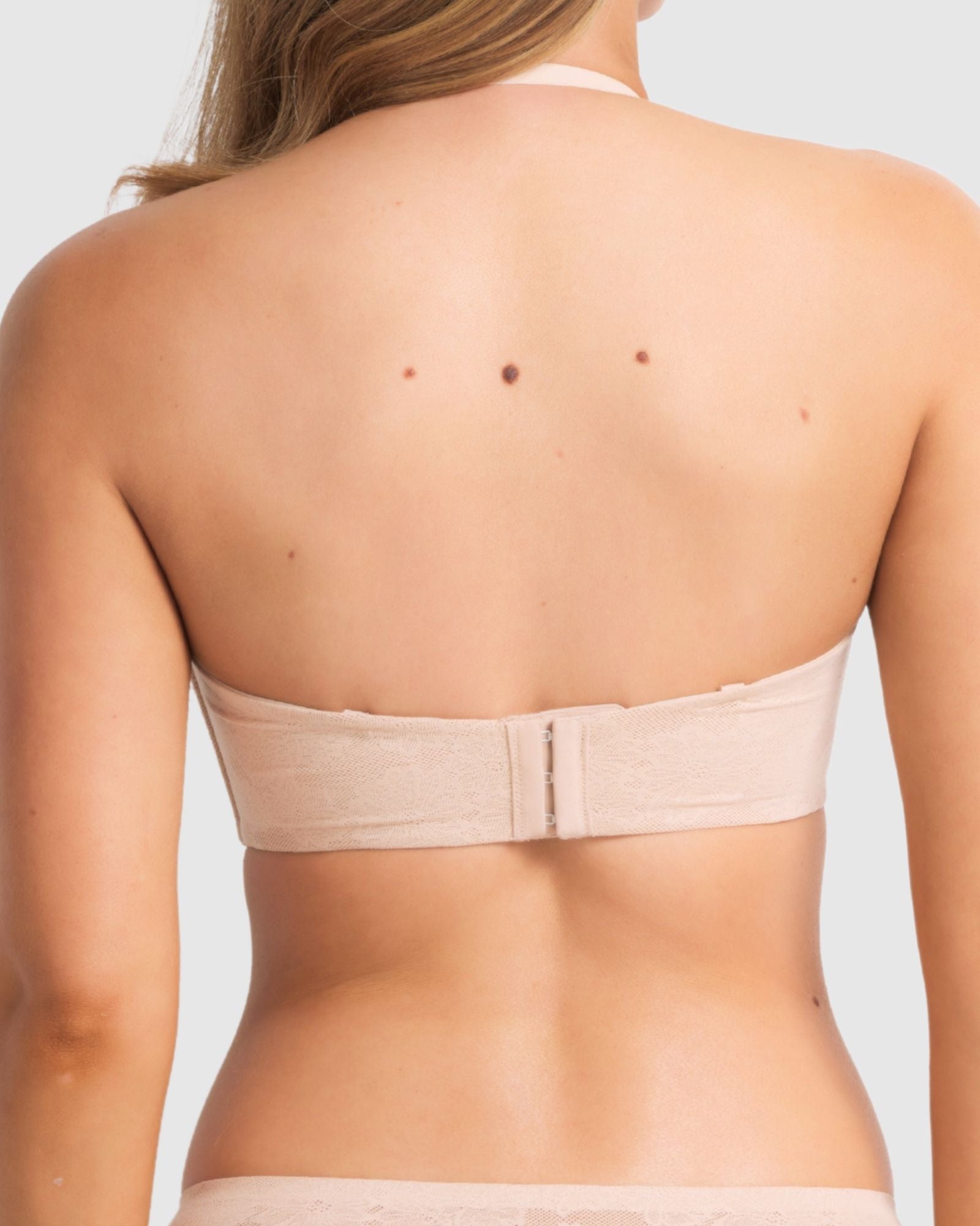 Model wearing the bra in strapless mode, focusing on secure fit and side boning support.