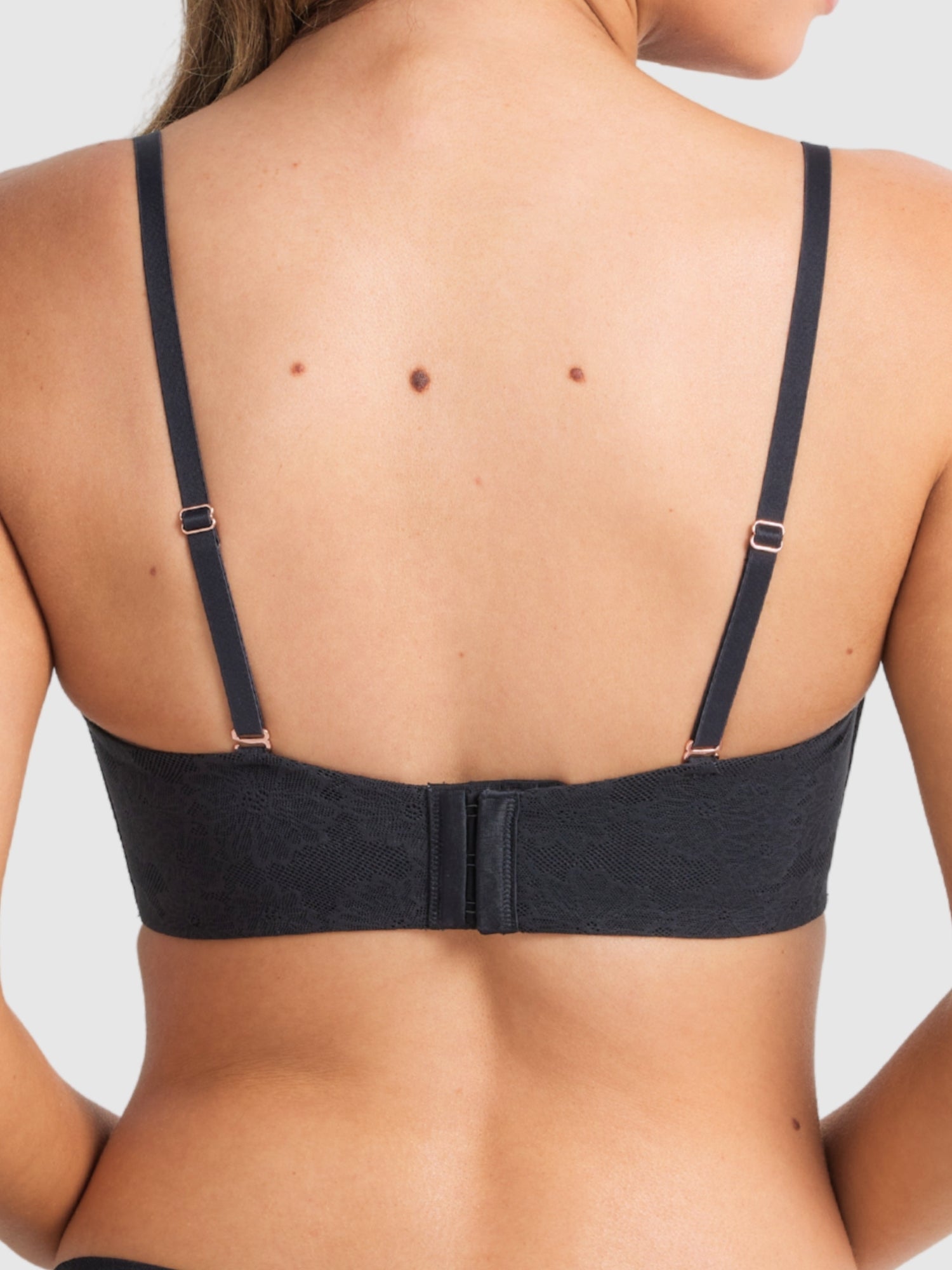 Model wearing the black strapless bra, emphasising secure support.