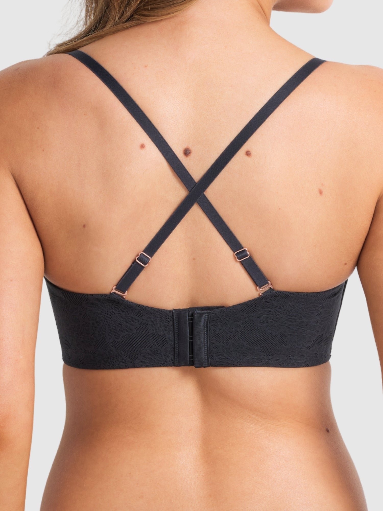 Model wearing the black strapless bra, emphasising secure support.