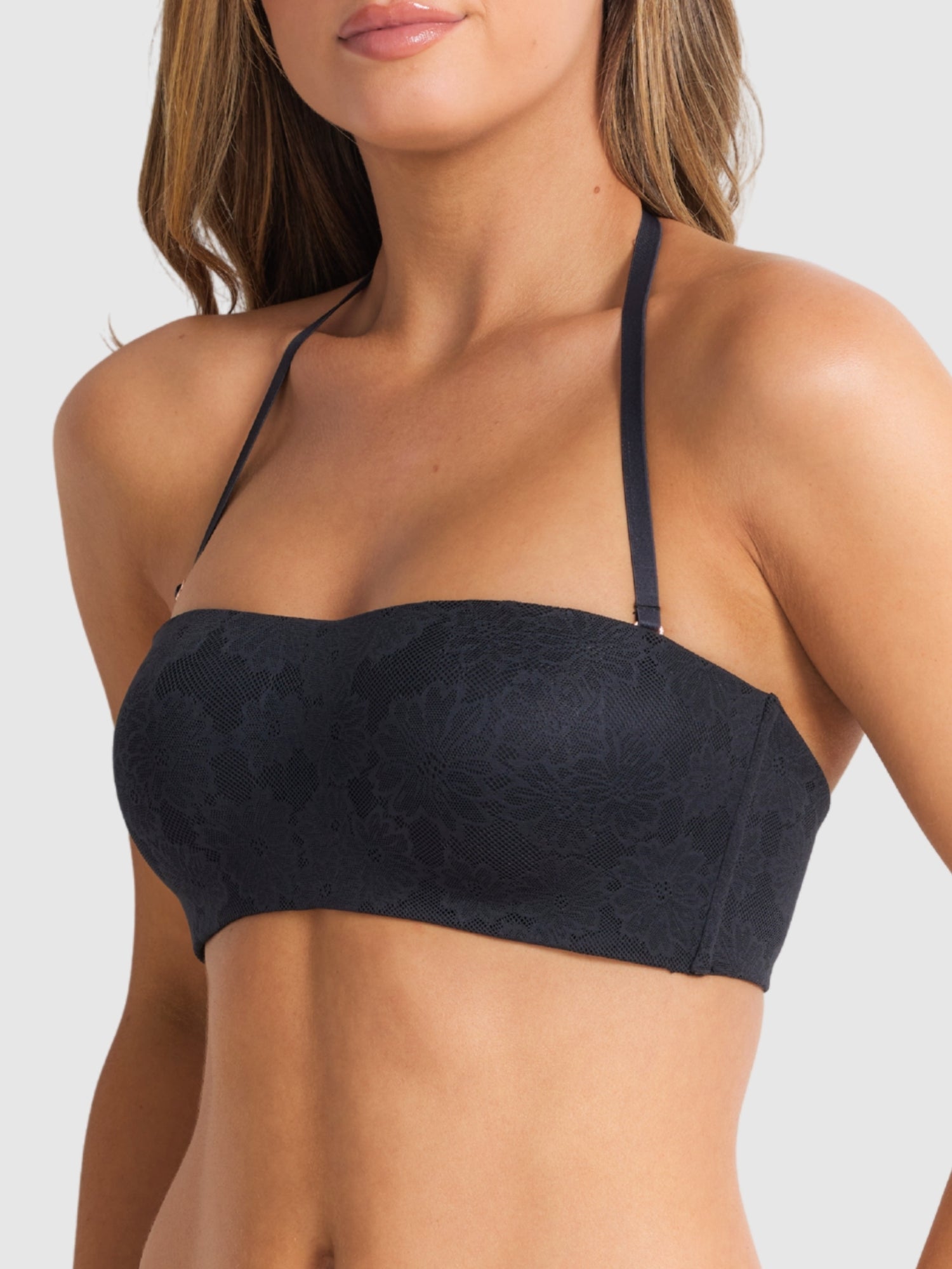 Model wearing the black strapless bra, emphasising secure support.