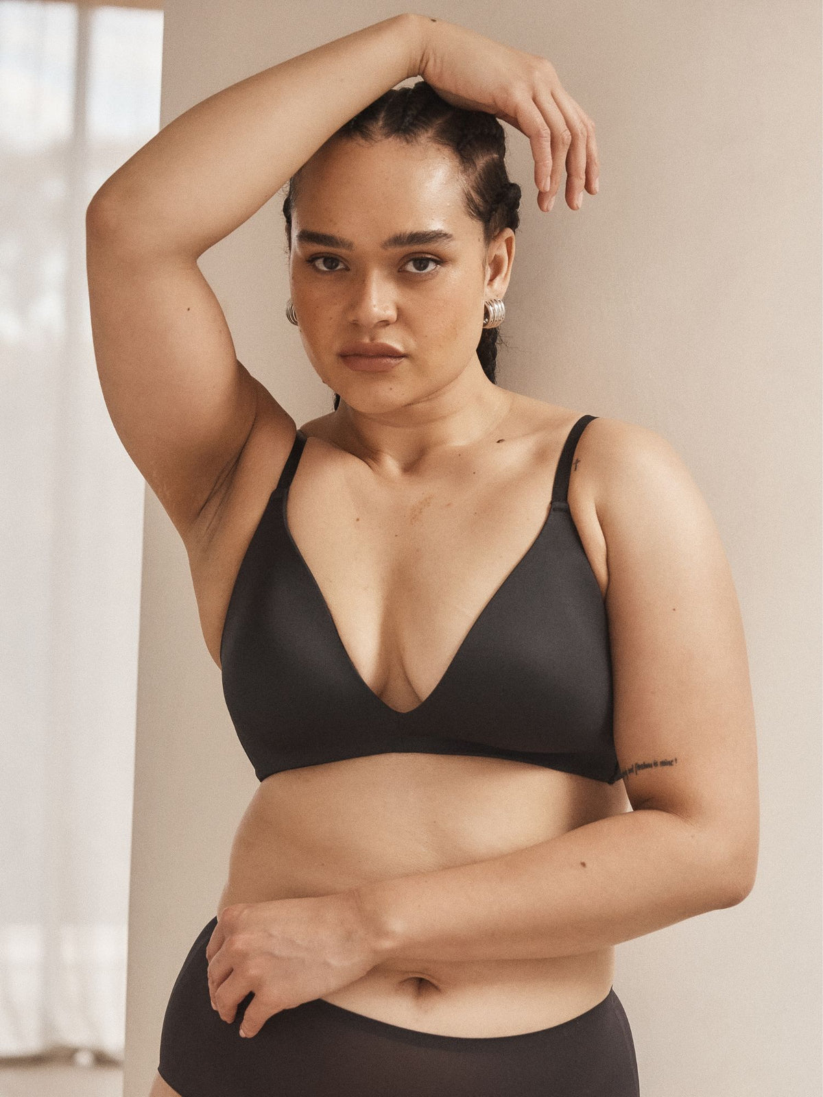 Channing wears the Attitude Wireless Plunge Bra in Black by Fine Lines Lingerie